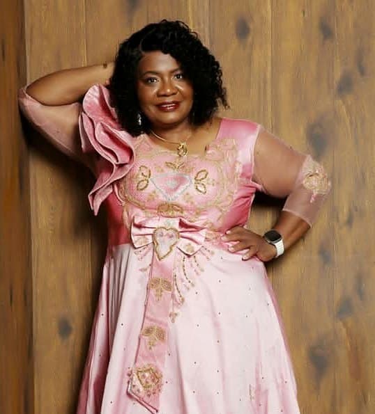 Pastor Catherine in a pink and gold gown