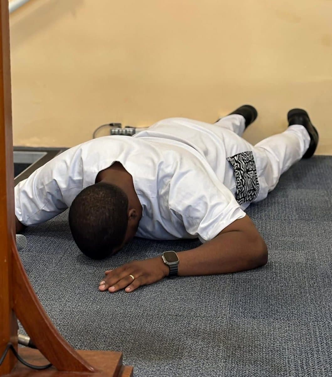 A man lying face down before the Lord in worship