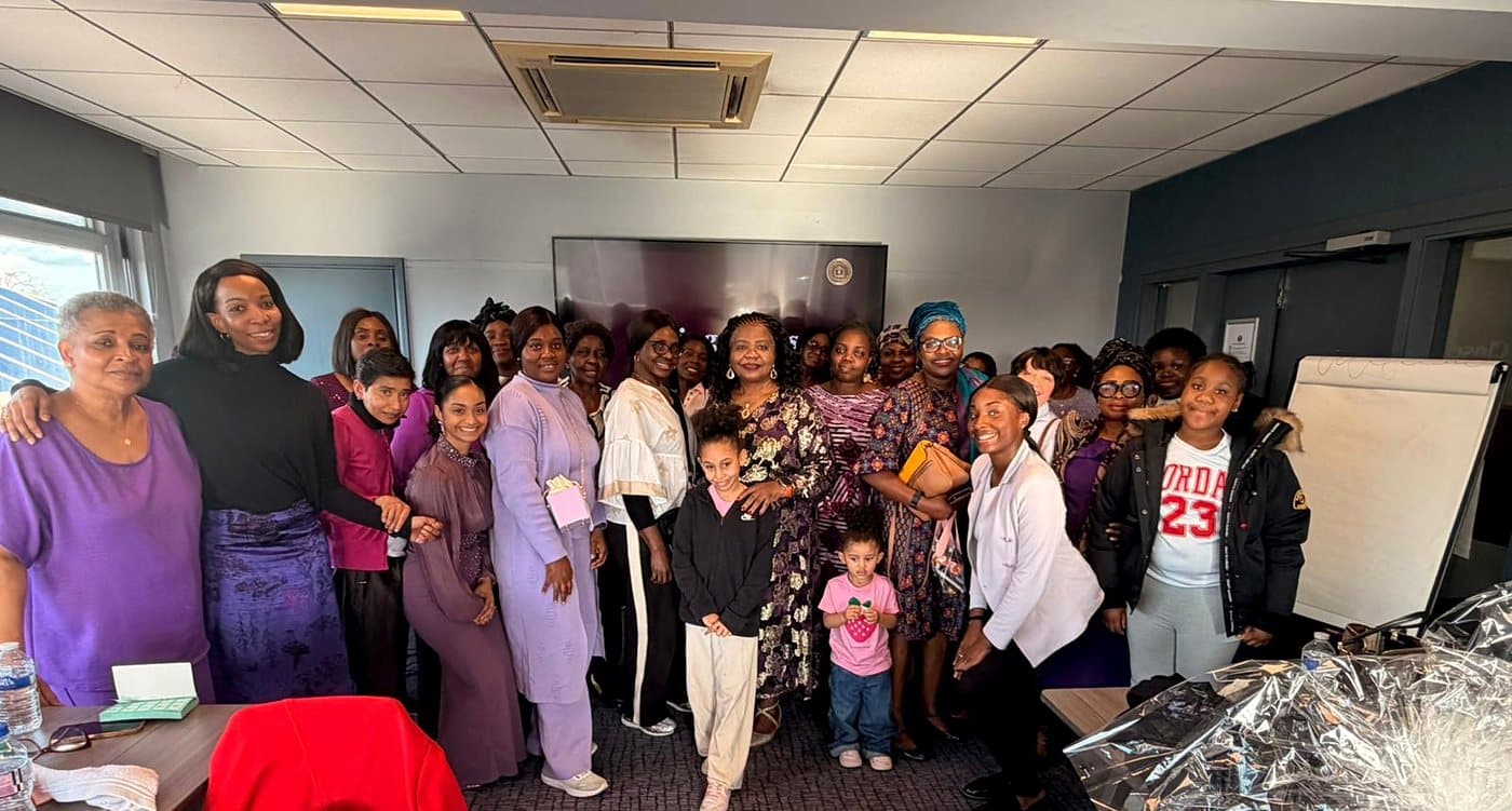 Women and girls of Daughters of the King gathered together, smiling